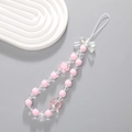 Pink beaded phone charm with butterfly and flower pendants on a white rippled base - Pink Bow Bear Beaded (K2077)