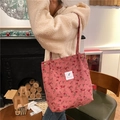 Dettaglio della borsa tote in velluto a coste rosa a fiori con toppe di testo sulla spalla - Rosa Rosa