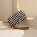 Women's black and white houndstooth clutch bag with brown leather wrist strap - Caramel color