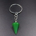 Macro detail of a green hexagonal agate stone pendant keychain with silver metal clip - Green Aventurine