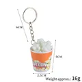 Realistic popcorn bucket keychain with red orange stripes and metal ring attachment - White