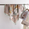 Detail of silk-like scarf featuring leopard print and palm leaves on a metal hanger - 66-70CM / Green Border