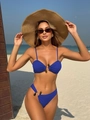 Detail view of blue ribbed bikini fabric featuring elegant dark olive hardware accents - Blue