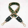 Close-up of beige and green jacquard wide strap with leather ends and gold metal buckles - No.7 Dark Green Jacquard + Green Leather