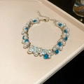 Vista macro detallada de la pulsera de plata con perlas blancas y piedras azules - Pulsera-Plata-Azul