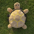Brown turtle plush pet backpack for small dogs with adjustable straps on grass - Turtle / Light Yellow