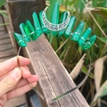 Detailed close-up of a handmade silver moon tiara with vertical green crystal pillars - Deep Green Crystal with Silver Wire & Moon