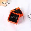 Orange jewelry gift box with black ribbon bow featuring heart-shaped pink crystal studs - 7.5x7.5x3.5cm / Orange