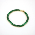 Close-up of 18K gold plated tennis bracelet with emerald green rectangular cubic zirconia - Green