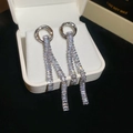 Macro shot of silver tassel earrings with zircon stones and cascading rectangular diamonds - Silver Double Circle Tassel Style (5997991211387)