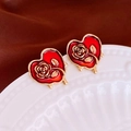Macro detail of vintage gold heart earrings with red enamel and embossed rose patterns - Silver Needle-Red Rose Heart Studs