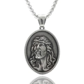 Macro detail of silver Jesus portrait pendant in stainless steel with relief texture - Jesus Profile Crown of Thorns
