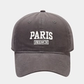 Close-up of white PARIS FRENCH embroidery on a dark grey cotton baseball cap texture - Gray