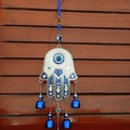 Vintage silver Hamsa Hand wall hanging with blue Evil Eye beads and three small bells - White