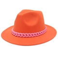 Detail of orange jazz fedora hat featuring a bold pink acrylic chain decoration - Orange