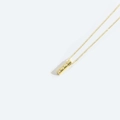 Minimalist gold necklace with a vertical bar pendant featuring three white pearls - Letter I