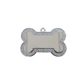 Macro shot of bone-shaped silver pet ID tag with sparkling diamond-encrusted edges - Silver