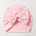 Detail of pink baby turban hat with golden polka dot bow and soft elastic fabric - Pink