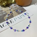Detail of evil eye beads and natural freshwater pearls with gold lobster clasp closure - Evil Eye Pearl Patchwork