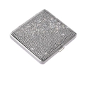 Detailed macro view of the sparkling rhinestone surface on a silver stainless steel case - White