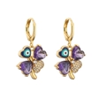 Detail of gold four-leaf clover earrings with purple heart stones and blue evil eye charms - Gold Purple Zirconia