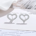 Sparkling silver heart stud earrings with cubic zirconia on a soft white feather background - Hollow Heart-shaped Earrings Led-106