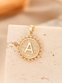Macro shot of gold-plated pendant with embossed letter A and vintage beaded edge detail - Gold Round Smooth Letter A