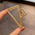 Golden alloy triangular metal hair claw clip with a polished finish and minimalist style - Medium Gold Triangle