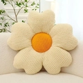 Floral petal plush cushion in beige and orange on a white textured sofa - White