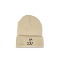 Close-up of I'M COLD embroidery on beige ribbed knit beanie with soft winter texture - Beige