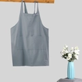 Gray-blue cotton linen apron with front pocket hanging on a wooden hook in a minimalist setting - Kids Grey