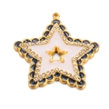 Makroaufnahme eines Goldstern-Anhängers mit schwarzen Wellenrändern und Perlmutteinlage - Schwarz & Weiß