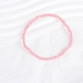 Detailed view of pink bohemian beaded bracelet set on a white textured background - Pink