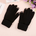 Detail of black knitted touchscreen gloves showing grey conductive tips and ribbed cuffs - Pineapple Texture Black
