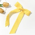 Detail of yellow satin hair clip with ruffled edges and elegant long ribbons - Yellow