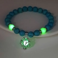Luminous beads and hollow lotus flower pendant glowing in the dark on a white tray - 8mm Natural Blue Turquoise with Green Light