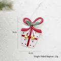 Christmas tin white gift box ornament with red bow and gold bells on snowy background - White Gift Box
