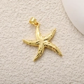 Golden starfish pendant charm with polished finish and lobster clasp on beach sand texture - A0773 Polished Starfish
