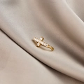 Macro detail of gold-plated cross ear cuff with micro-pave cubic zirconia on silk - Cross (E5689-13)