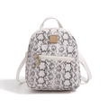 Detail of a mini backpack featuring white snake print PU leather and gold-tone hardware - Black & White
