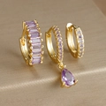 Macro shot of three-piece gold drop earrings set with purple rhinestones on silk surface - Three-Piece Set / Gold - Purple Zirconia