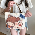 Cream canvas tote bag with cartoon girl print and brown handles in home setting - Girl and Rabbit