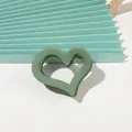 Detail shot of heart-shaped green matte hair claw clip with internal anti-slip teeth - Small Heart - Fruit Green