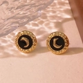 Macro detail of vintage gold round earring with black enamel and crescent moon design - Black
