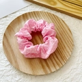 Pink and white polka dot scrunchie made of soft fabric on a wooden tray - Pink with White Polka Dots