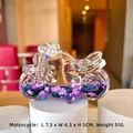 Detail view of colorful liquid motorcycle bottle keychain measuring 7.3 x 4.3 x 5 cm - Black Purple