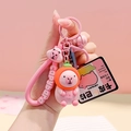 Pink Capybara keychain with orange hood, matching wrist strap and small metal bell charm - Persimmon Pink Capybara PVC