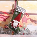 Green Christmas stocking gift bag with gray polka dot trim and a cute red gnome figure - Green Forest Gnome Stocking