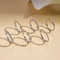 Detail of 7-piece silver finish ring set with zirconia stones on a neutral background - Silver (6-Piece Set)