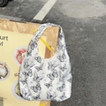 Close-up of textured white canvas bag with delicate black butterfly print in street setting - Vest Style Black